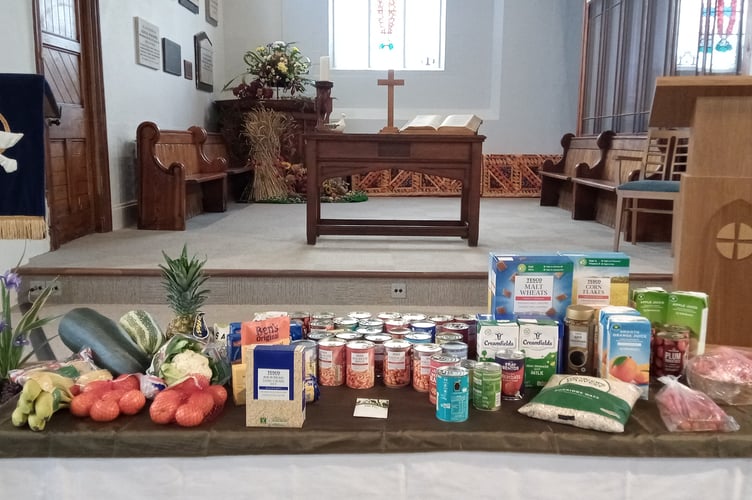 The offering of harvest gifts for the Foodbank during the service.
