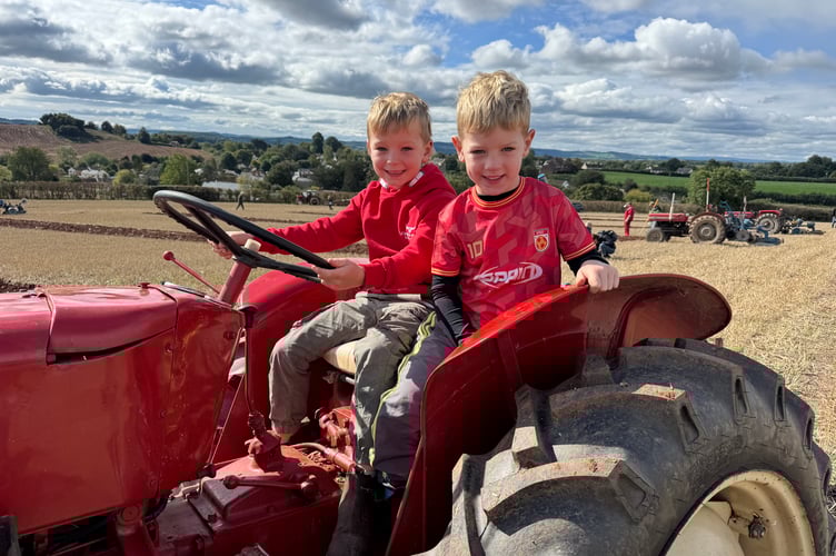 Toby (7) and Wilf (5) enjoyed sitting on their grandads tractor at Cheriton Fitzpaine Ploughing Match.  AQ 3587
