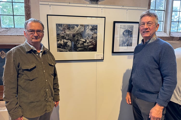 Tom Langdon-Davies, left and Gordon Hepworth beside some of the Ravilious images on display at Newton St Cyres Church until 4pm on Friday, October 3.  AQ 2750
