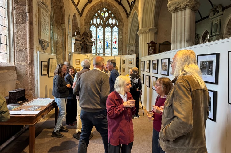 Some of those who attended the exhibition of photographs open evening in Newton St Cyres Parish Church. AQ 2749
