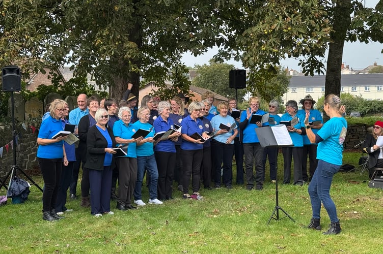 Copplestone Community Choir singing before the heaven’s opened. AQ 2874