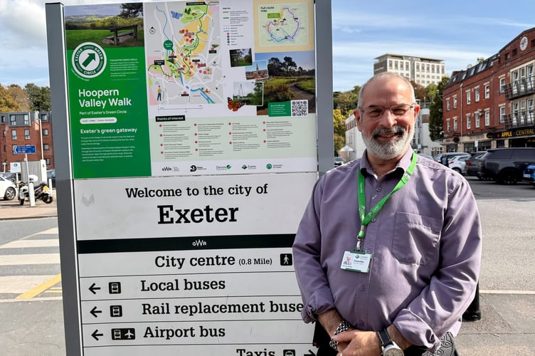Exeter City Councillor Duncan Wood beside the Green Circle sign at Exeter St David’s Station.