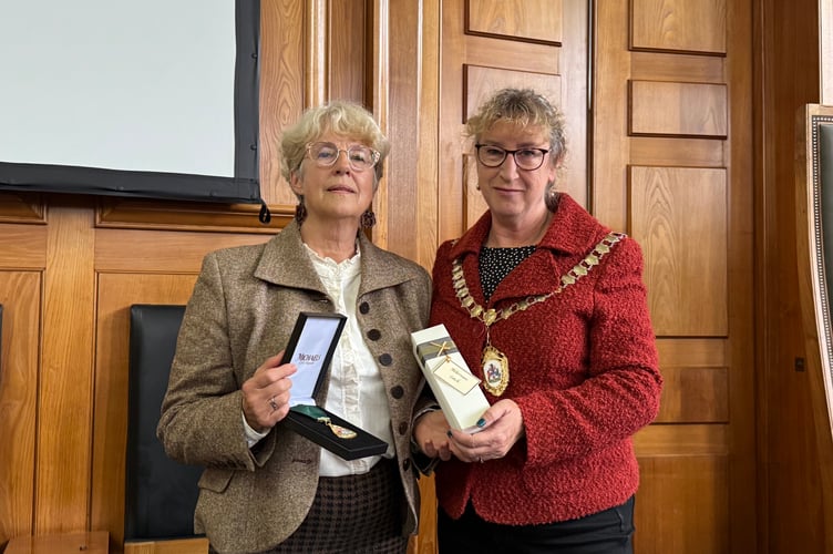 Natalia Letch, a Mid Devon District Councillor, received the posthumous award for her late husband, Frank Letch from DCC chair, Cllr Caroline Leaver. AQ 4396