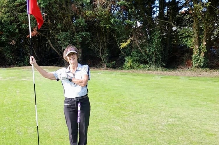 Lyn Parry celebrating her hole in one on the third green. 
