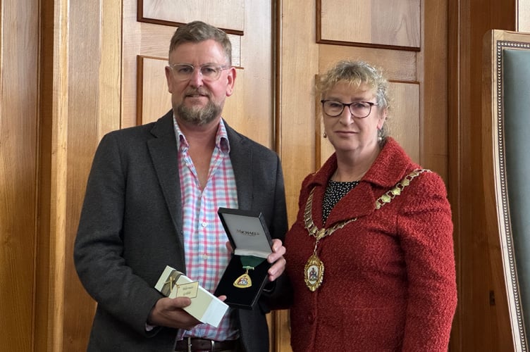 Mark Gribble received the Honour for George Gribble who served as County Councillor for Bovey Tracey Rural from 2009 to 2025. AQ 4414