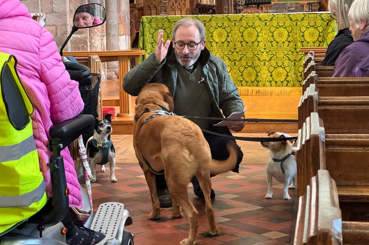 Rev Matthew Tregenza blessing one of the pets during the service. AQ 4904