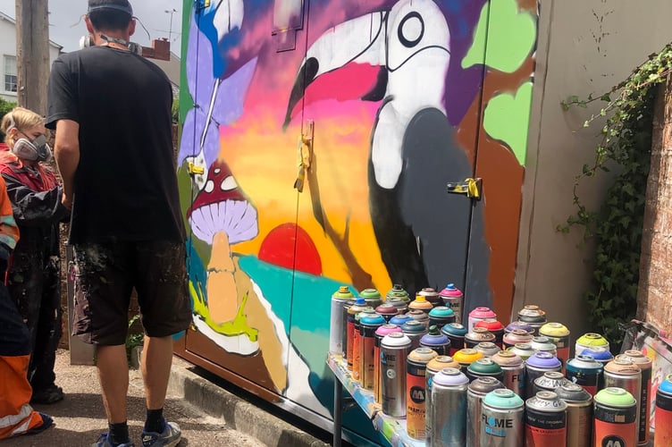 Nick Olas teaching young people how to create the piece of art.