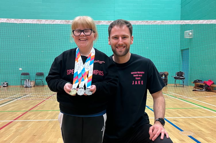 Dee Weiner with her medals and coach Jake.