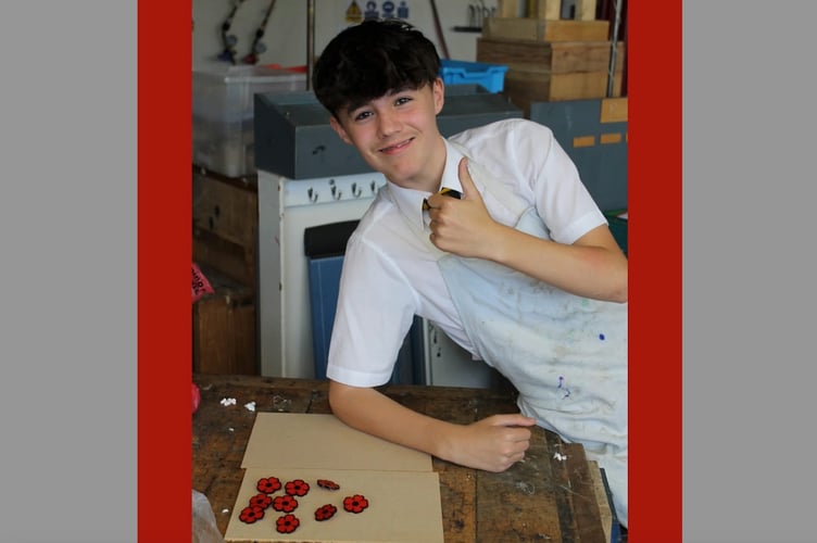 One of the Year 10 Design and Technology QE students with some of the acrylic poppies created.
