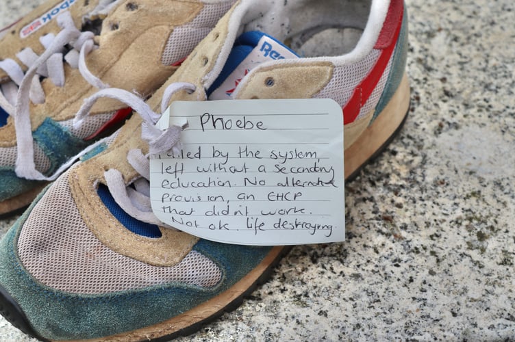 Handwritten tags with the names and stories of local children were tied to each pair