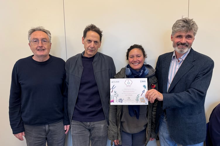 The St Lawrence Green Group received a Level 5 It’s Your Neighbourhood Outstanding certificate from Crediton Town Councillor Giles Fawssett. AQ 7212