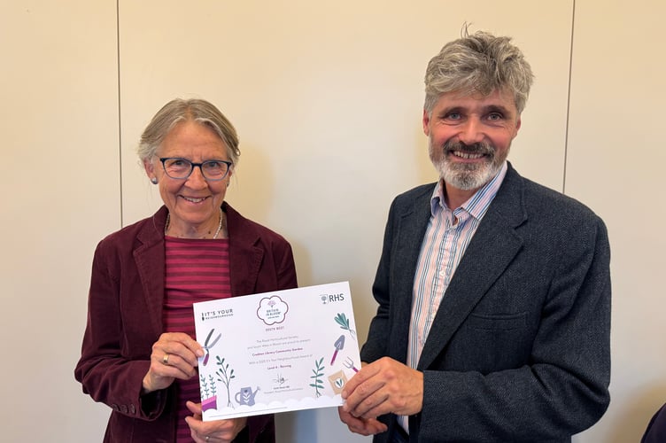 Crediton Library received a Level 4 It’s Your Neighbourhood Thriving certificate from Crediton Town Councillor Giles Fawssett. AQ 7216