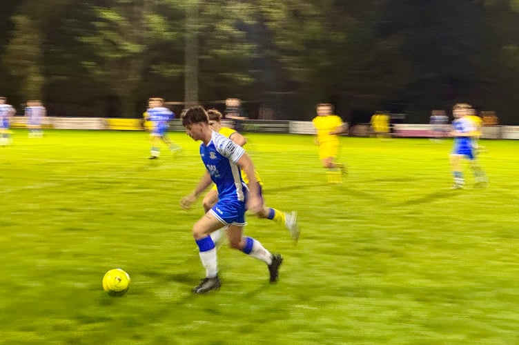 A Crediton player with the ball. AQ 6744