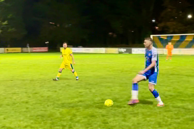 A Crediton player with the ball. AQ 6750