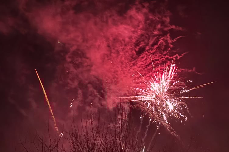 Red and white fireworks over Crediton. AQ 7424