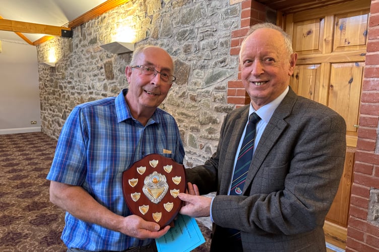 Kelvin Phillips won the Devon County Ploughing AssociationVintage Hydraulic shield, presented by President Raymond Govier. AQ 7125
