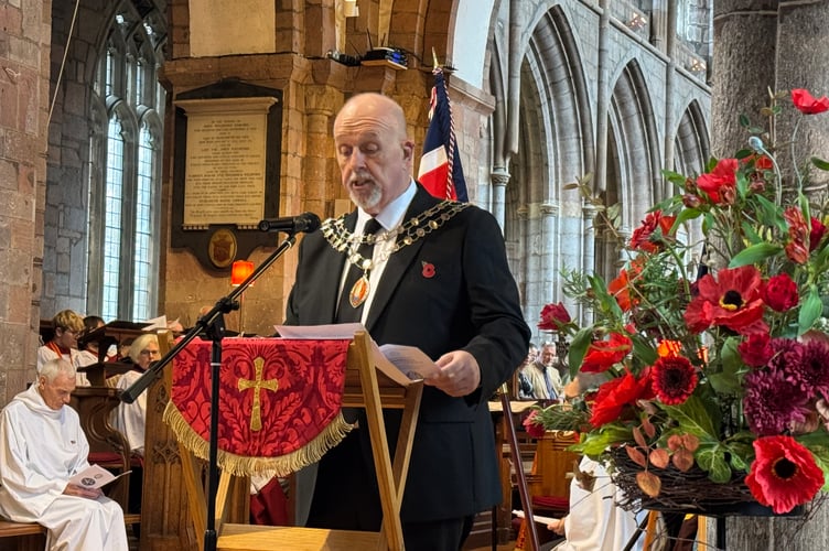 The Mayor of Crediton, Cllr Steve Huxtable, read the first reading for the Service of Remembrance. AQ 7532
