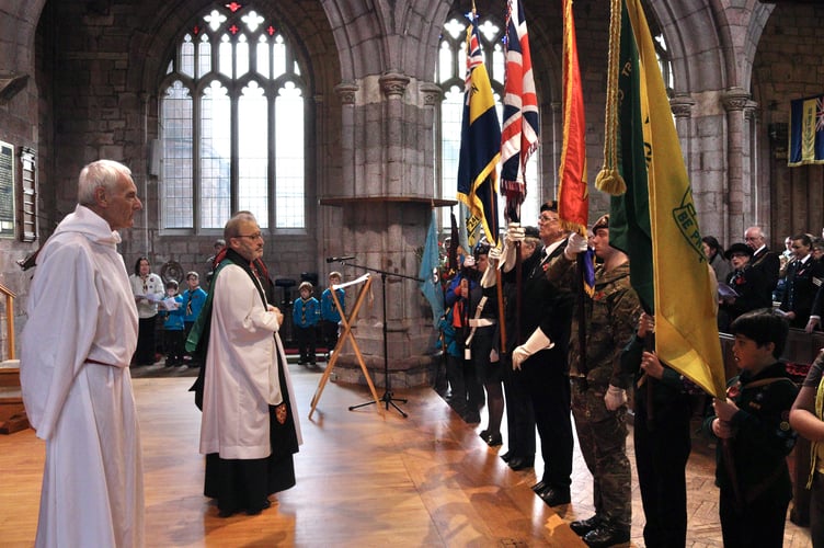 Cadets, scouts and others presenting standards at nave altar