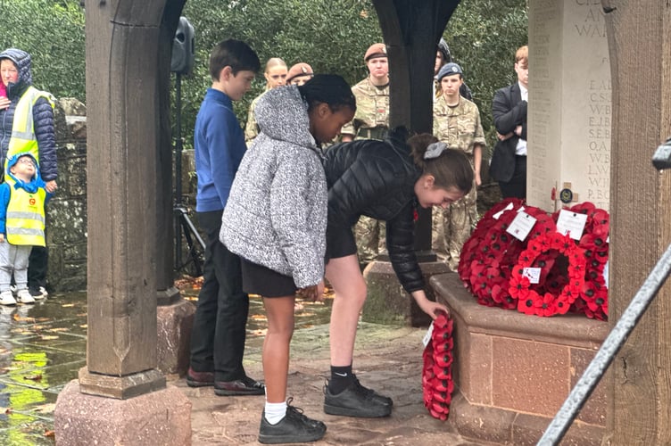 Children laying a wreath at Crediton War Memorial. AQ 7750