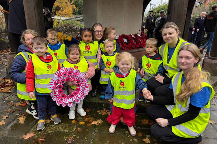 Pippins Nursery children, staff and helpers with the wreath the pre-school laid at the War Memorial. AQ 7731