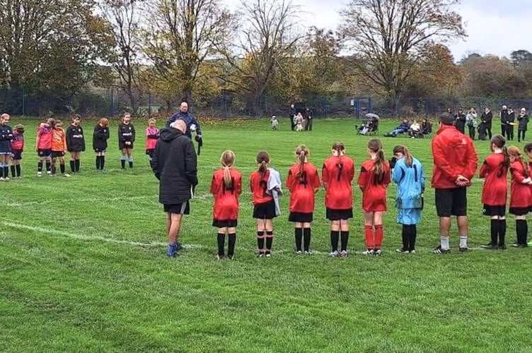 U11 girls observing a two-minutes silence at Lords Meadow on Sunday morning