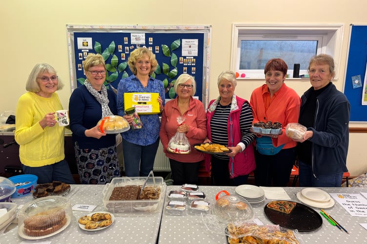 Helpers behind the cake stall at Copplestone Church in aid of Children in Need with Suzanne Lunn, fourth left. AQ 8075