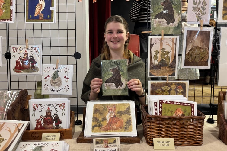 Amelia of Folk Fauna, a graduate of illustration, from Bradninch, sold prints, bookmarks, badges and cards of her illustrations.  AQ 8049
