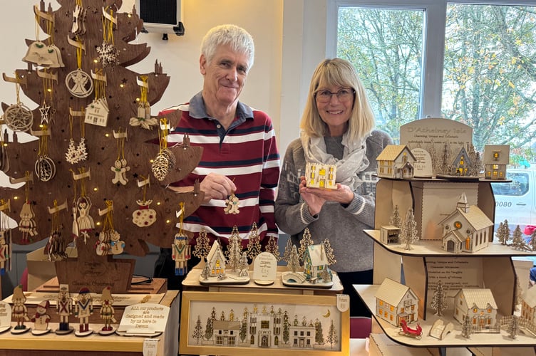 Simon and Kathryn D’Arcy of Teignmouth had a stall at Sandford. Kathryn produces seasonal houses, collages, 3D pictures and more, Simon producing wooden items, book covers and decorations.  AQ 8042
