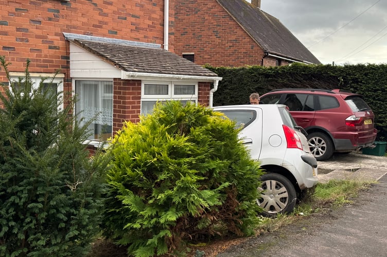 The silver coloured car in the front garden of the Spruce Park property. AQ 8294