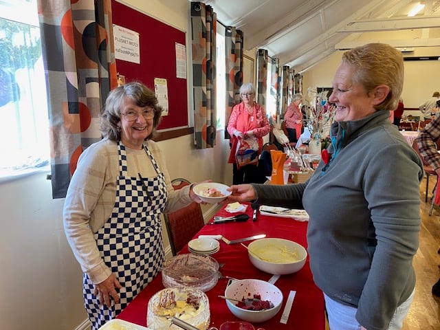 Yvonne Clayton serves a pud to Ann Nixon at Cheriton Fitzpaine.