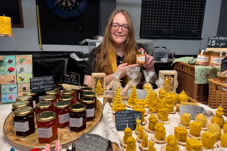 Emma Benjamin from Cheriton Bishop is a hobby beekeeper and makes candles, sells honey and other products, here at The Ship Craft Fair. AQ 7989
