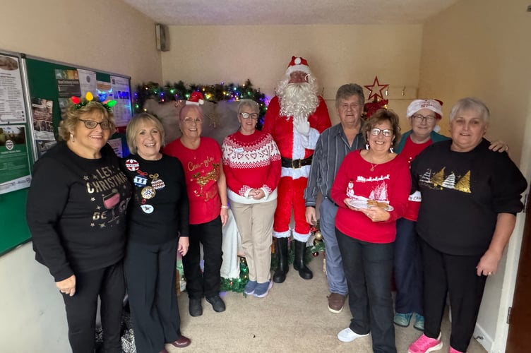 Father Christmas with helpers at Bow Christmas Market.  AQ 8546

