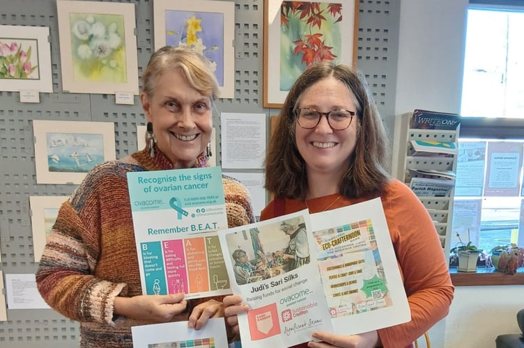 Judi Binks, left, and Catherine West holding posters highlighting the Eco-Crafternoon and symptoms of ovarian cancer