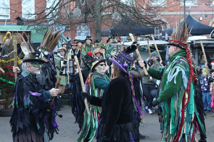 29 November 2025 Christmas lights switch-on Otter Morris and Grimspound Morris dancers mid-frolic (Will Goddard, Crediton Courier)