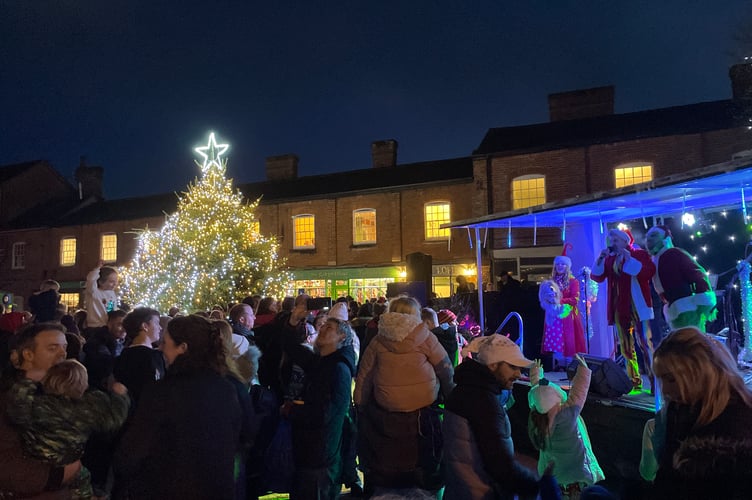 MC Rob Pudner and the Grinch on stage as the lights were switched on