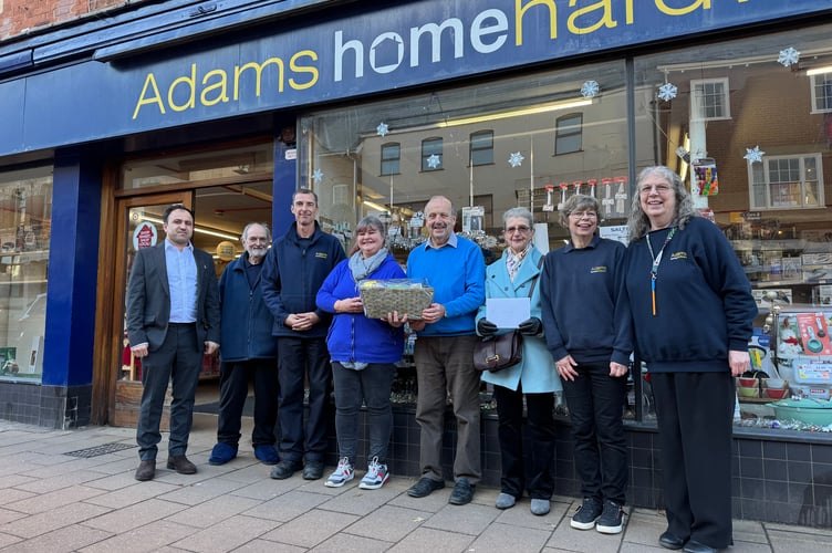 David Adams, fifth left, received a hamper to mark his retirement from Adams Home Hardware.  AQ 8477
