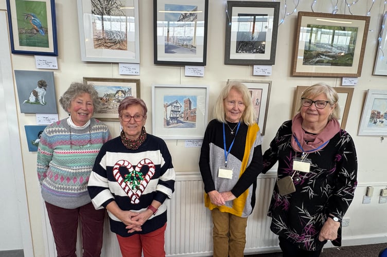 Some of the members of Newton St Cyres Art Group in front of their exhibition of works.  AQ 9907
