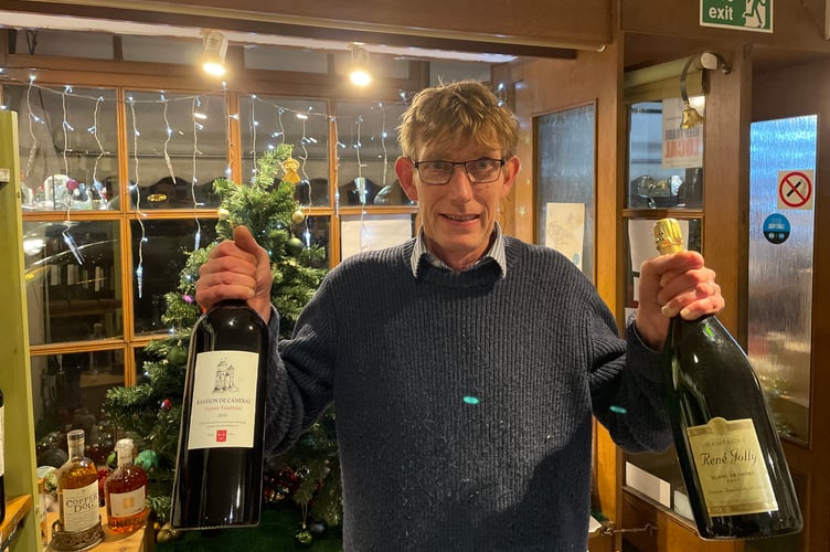 5 December 2025 Late-night Christmas shopping Bruce Evans of Grape and Grain with some choice wine and champagne (Will Goddard, Crediton Courier)