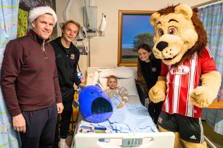 Sophia Voigts, 10, with Gary Caldwell, Ilmari Niskanen, Sophie Gillies and Grecian the Lion