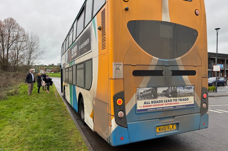 People getting off a Stagecoach bus onto the grass verge opposite Redlands Surgery in Joseph Locke Way. AQ 0244
