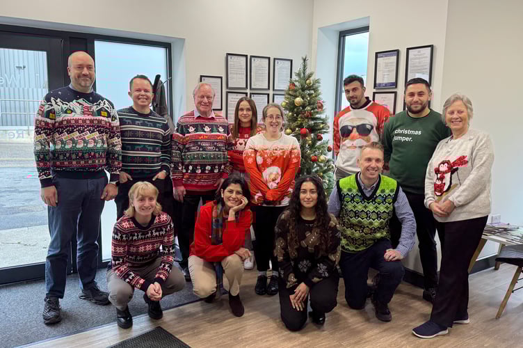 The staff from Crediton Dairy who wore Christmas jumpers to support the charity, Save the Children. AQ 0347