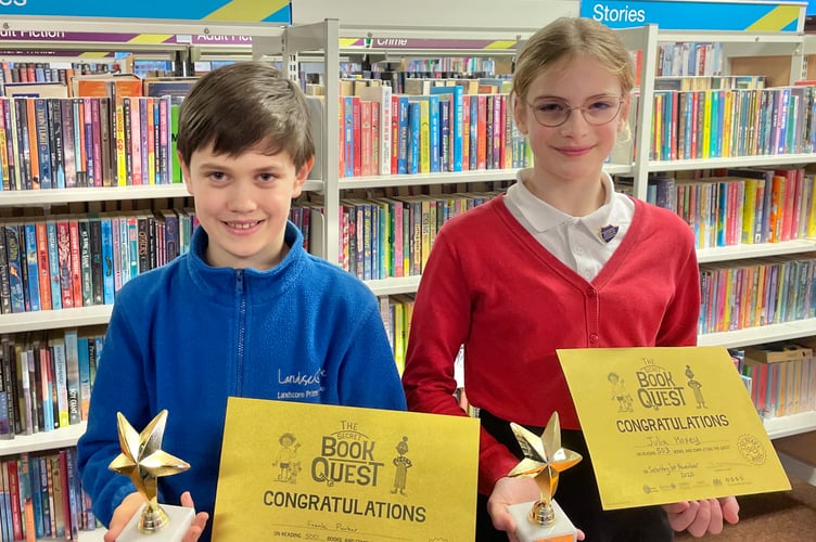 Frank and Julia with trophies and certificates at Crediton Library