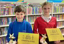 Trophies for pair who read 500 books in library challenge