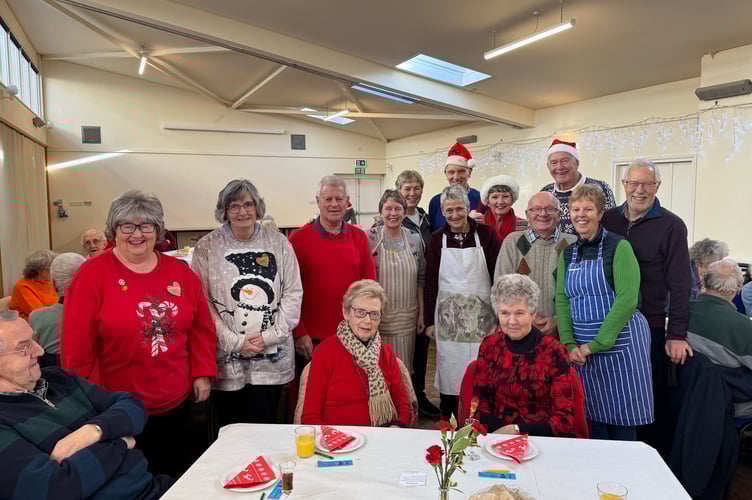 Members of the Rotary Club of Crediton Boniface and guests at the Senior Citizens Tea Party with Hazel Evely, Morrisons Community Champion, left. AQ 0504