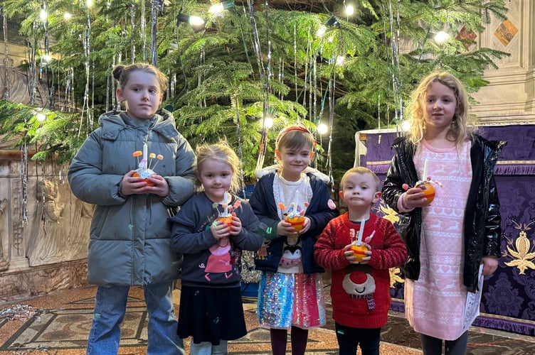 Lots of children with the Christingles they had made.  AQ 0661
