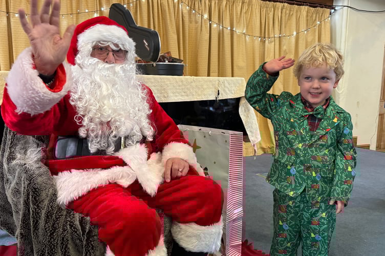 A wave from Father Christmas and a well-dressed youngster at Crediton Congregational Church Toddler Group.  AQ 0751
