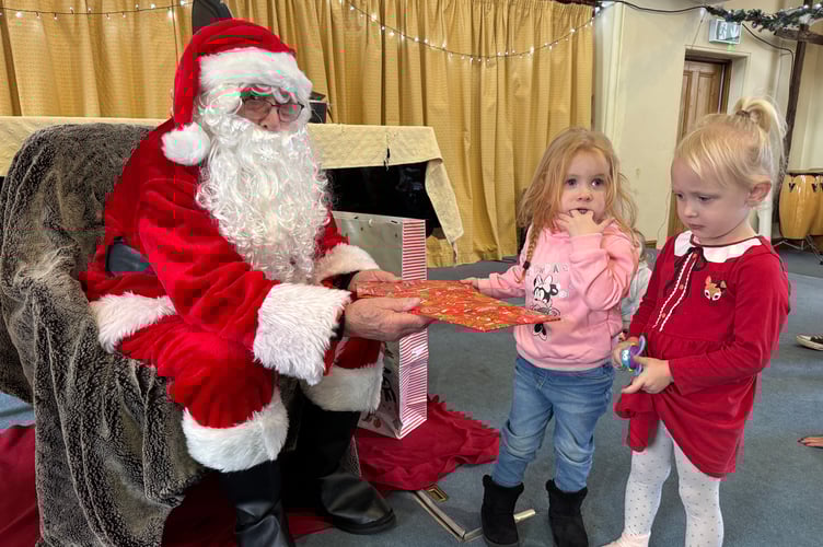 Father Christmas gave presents to all the children he met at Crediton Congregational Church Toddler Group.  AQ 0744
