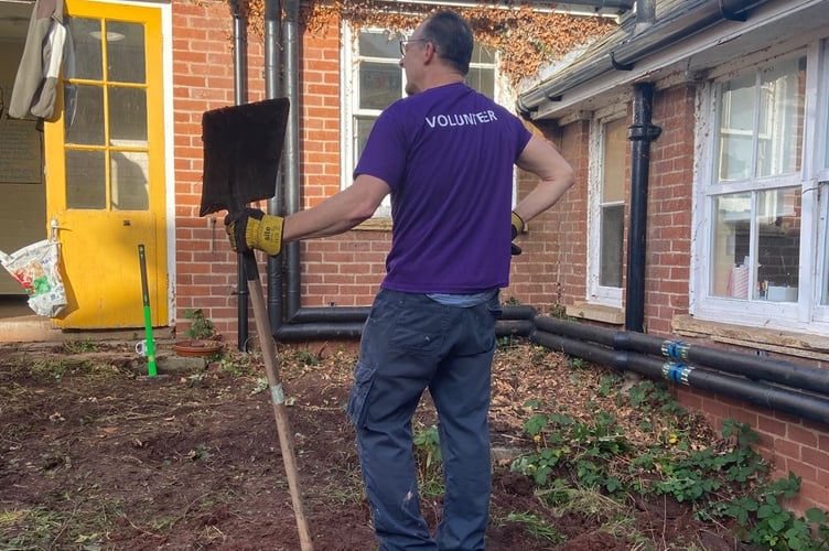 An Ernest Jackson volunteer admires his work.
