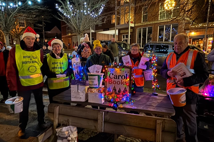 Volunteers offered Carol booklets for a donation at Carols in the Square.  AQ 1224
