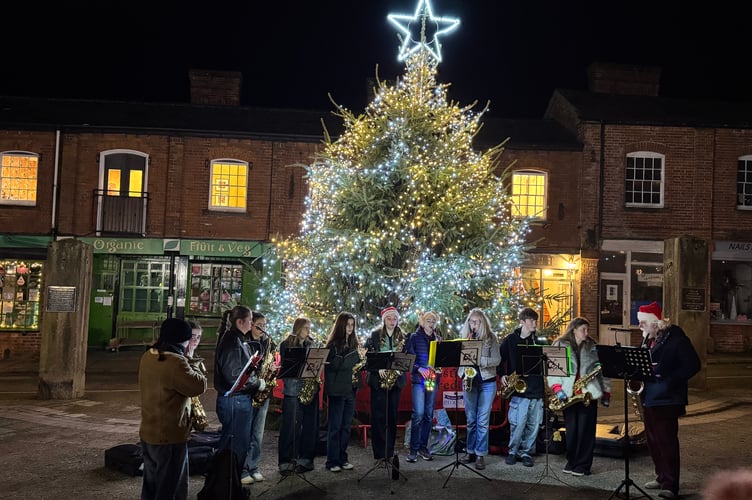 Members of Crediton Youth Saxophone Ensemble, part of Crediton Youth Orchestra, entertained in front of the giant Christmas tree.  AQ 1222
